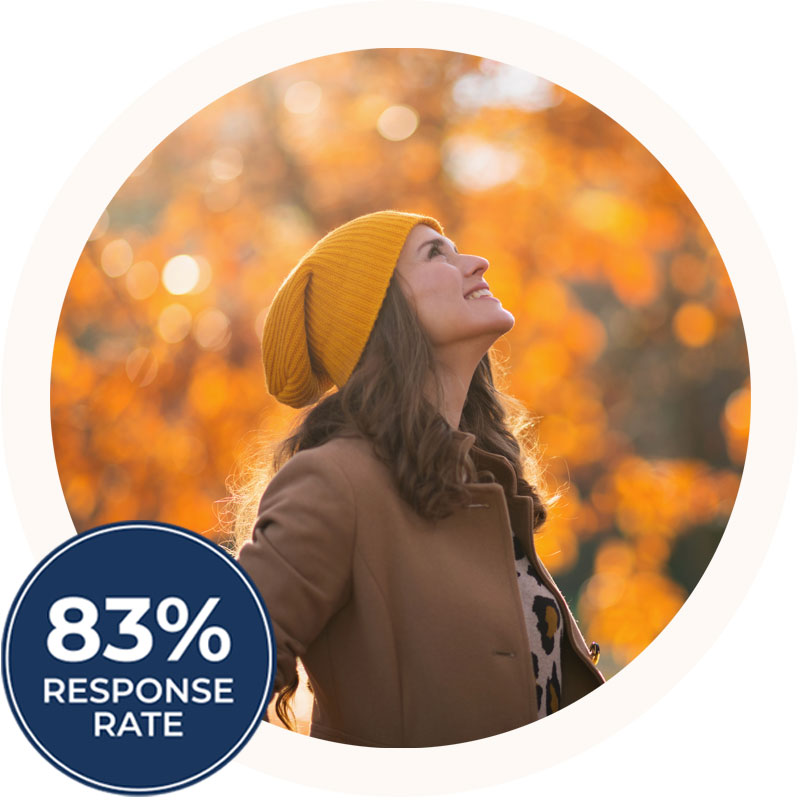 A young woman looking happy after getting tms therapy in san diego